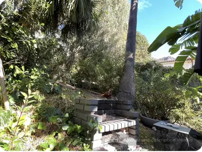 a bird sitting on a hammock under a palm tree at Petite Villa Eze Bord de Mer in Èze
