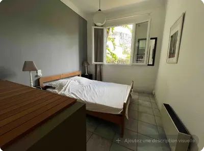 a small bedroom with a bed and a window at Petite Villa Eze Bord de Mer in Èze