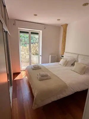 a bedroom with a large bed with two towels on it at Cozy Villa Saint-Jean-Cap-Ferrat in Saint-Jean-Cap-Ferrat