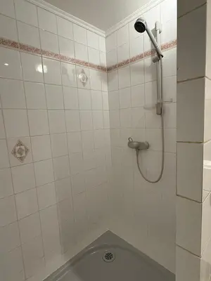a white tiled bathroom with a shower and a tub at Cozy Villa Saint-Jean-Cap-Ferrat in Saint-Jean-Cap-Ferrat
