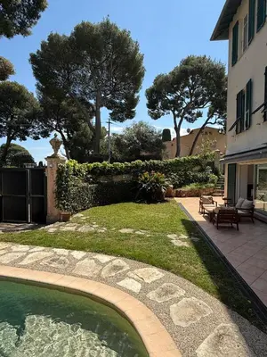 a swimming pool in a yard next to a building at Cozy Villa Saint-Jean-Cap-Ferrat in Saint-Jean-Cap-Ferrat
