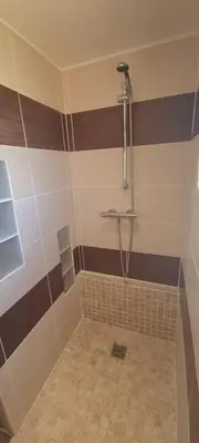 a bathroom with a shower with brown and white stripes at Saint-Jeannet Studio apartment near Nice in Saint-Jeannet