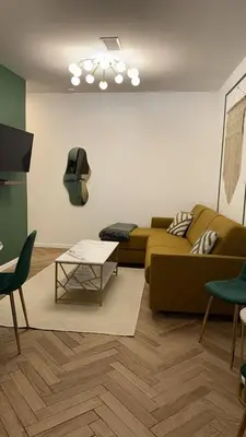 a living room with a couch and a table at MOON 25 in Nice