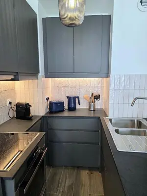 a kitchen with dark blue cabinets and a sink at 