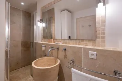 a bathroom with a tub and a shower with a mirror at 