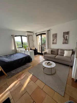 a living room with a bed and a couch at Maison Lou in Falicon