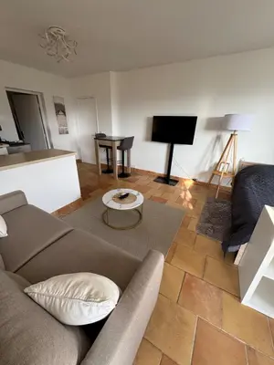 a living room with a couch and a television at Maison Lou in Falicon