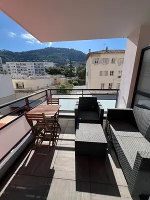 a balcony with chairs and tables on a building at Nice 2P quiet, tram, convenient in Nice