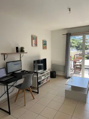 a living room with a desk with a computer on it at Nice 2P quiet, tram, convenient in Nice