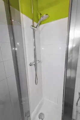 a shower with a glass door and a shower at L'Opéra - Hypercentre - Cosy - No elevator - Minimalist - Sea in Nice