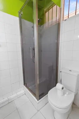 a bathroom with a toilet and a glass shower at L'Opéra - Hypercentre - Cosy - No elevator - Minimalist - Sea in Nice