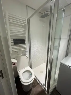 a small bathroom with a toilet and a shower at Studio Masséna Nice in Nice