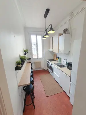 a small kitchen with a counter and a sink at Superbe appartement niçois in Nice