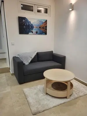 a living room with a couch and a table at Studio haut de gamme in Nice
