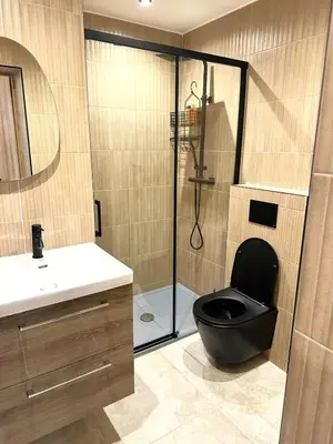 a bathroom with a black toilet and a shower at Studio Californien à deux pas de la plage in Nice