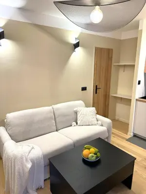 a living room with a couch and a table at Studio Californien à deux pas de la plage in Nice