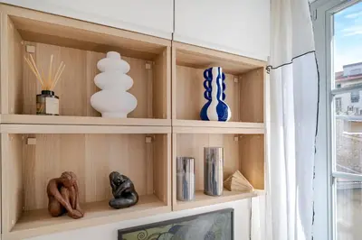 a shelf with vases and other items on it at Studio lumineux Centre-ville in Nice