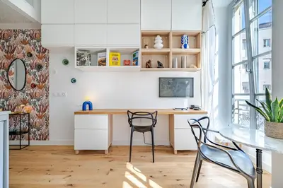 a kitchen with a desk and chairs in a room at Studio lumineux Centre-ville in Nice
