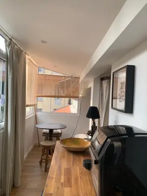 a living room with a wooden table and a table at Grand studio Zen à côté de la promenade des Anglais in Nice