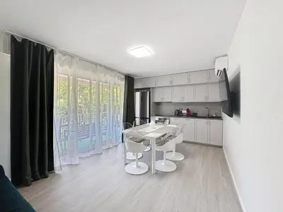 a kitchen with a table and chairs in a room at Azur Stay in Nice