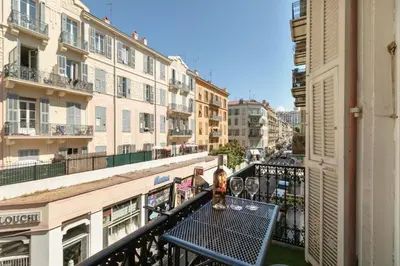 a table on a balcony in a city with buildings at Maison Bianchi - Downtown Nice Pertinax in Nice