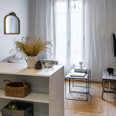a living room with a table and a window at Appartement moderne proche mer et transports in Nice