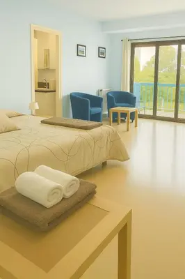 a bedroom with two beds with towels on a table at Studio proche de la mer avec parking Cagnes-sur-Mer in Cagnes-sur-Mer