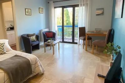 a living room with a bed and a table and chairs at Studio proche de la mer avec parking Cagnes-sur-Mer in Cagnes-sur-Mer