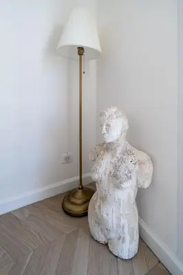 a statue of a man sitting next to a lamp at Studio moderne proche mer - Balcon et Climatisé in Nice