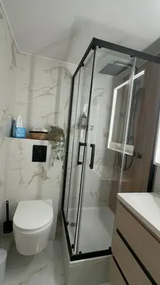a white bathroom with a shower and a toilet at La vie est belle - T2 - Coeur de Nice in Nice