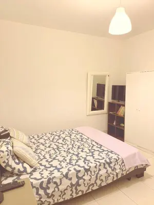 a bedroom with a bed with a blue and white blanket at 3 pièces près du Port de Nice in Nice
