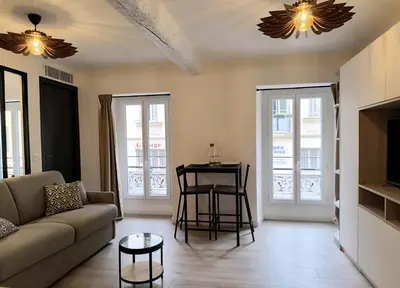 a living room with a couch and a table at Seytour Central Place in Nice