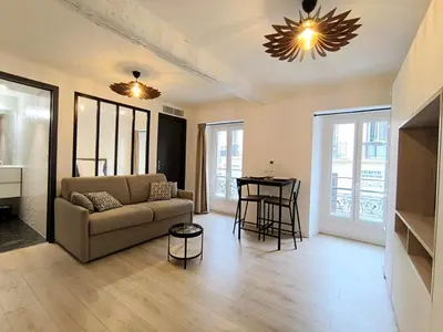 a living room with a couch and a table at Seytour Central Place in Nice