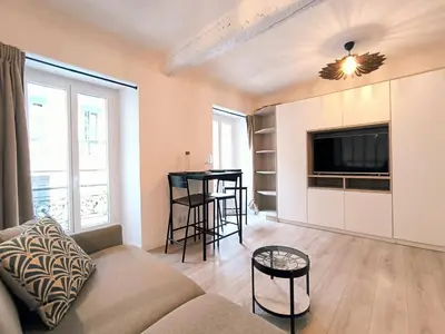 a living room with a couch and a tv at Seytour Central Place in Nice