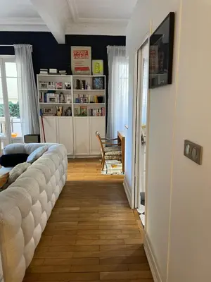 a living room with a couch and a television in a room at Palais Libération 3 pièces in Nice