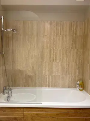 a bathroom with a bath tub with a shower at Rivoli Center Terrasse Clim Parking in Nice