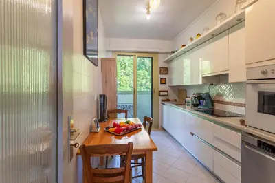 a kitchen with a table with a bowl of fruit on it at ALTAIR AP4466 by RIVIERA HOLIDAY HOMES in Nice