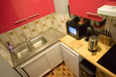 a small kitchen with a sink and a microwave at l'Or dans la Mer Partner in Nice