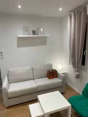 a living room with a couch and a table at Studio cosy - Nice Mont Boron in Nice