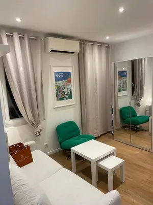 a living room with a white couch and green chairs at Studio cosy - Nice Mont Boron in Nice
