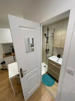 a bathroom with a shower and a sink and a door at Studio cosy - Nice Mont Boron in Nice