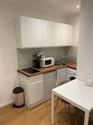 a kitchen with white cabinets and a microwave at Studio cosy - Nice Mont Boron in Nice