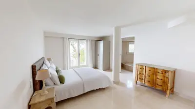 a white bedroom with a bed and a window at Villa Ezea - vue mer et charme in Èze