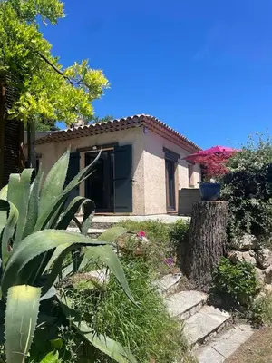 a small house with a yard with plants in front of it at La Petite Maison des Baous in Saint-Jeannet