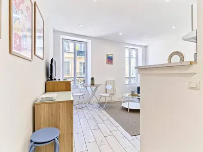 a kitchen and living room with white walls and windows at Studio Hyper Centre - WIFI - Central in Nice