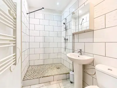 a white bathroom with a shower and a sink at Studio Hyper Centre - WIFI - Central in Nice