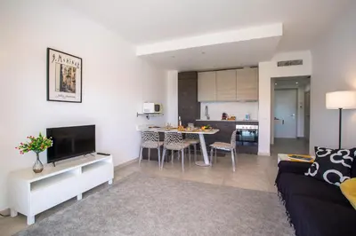 a living room with a couch and a table with chairs at VISTA MARE AP4459 By Riviera Holiday Home in Villefranche-sur-Mer