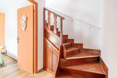 a wooden staircase in a living room next to a door at Maison 6-7p, Terrasses, proche Plages, Nice Centre in Nice