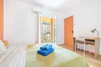a bedroom with a bed with blue towels on it at Maison 6-7p, Terrasses, proche Plages, Nice Centre in Nice