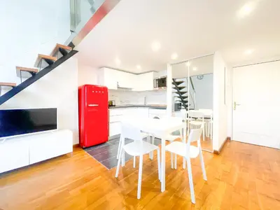 a kitchen with a red refrigerator and white tables and chairs at Place Massena 4 Pers AC WiFi in Nice